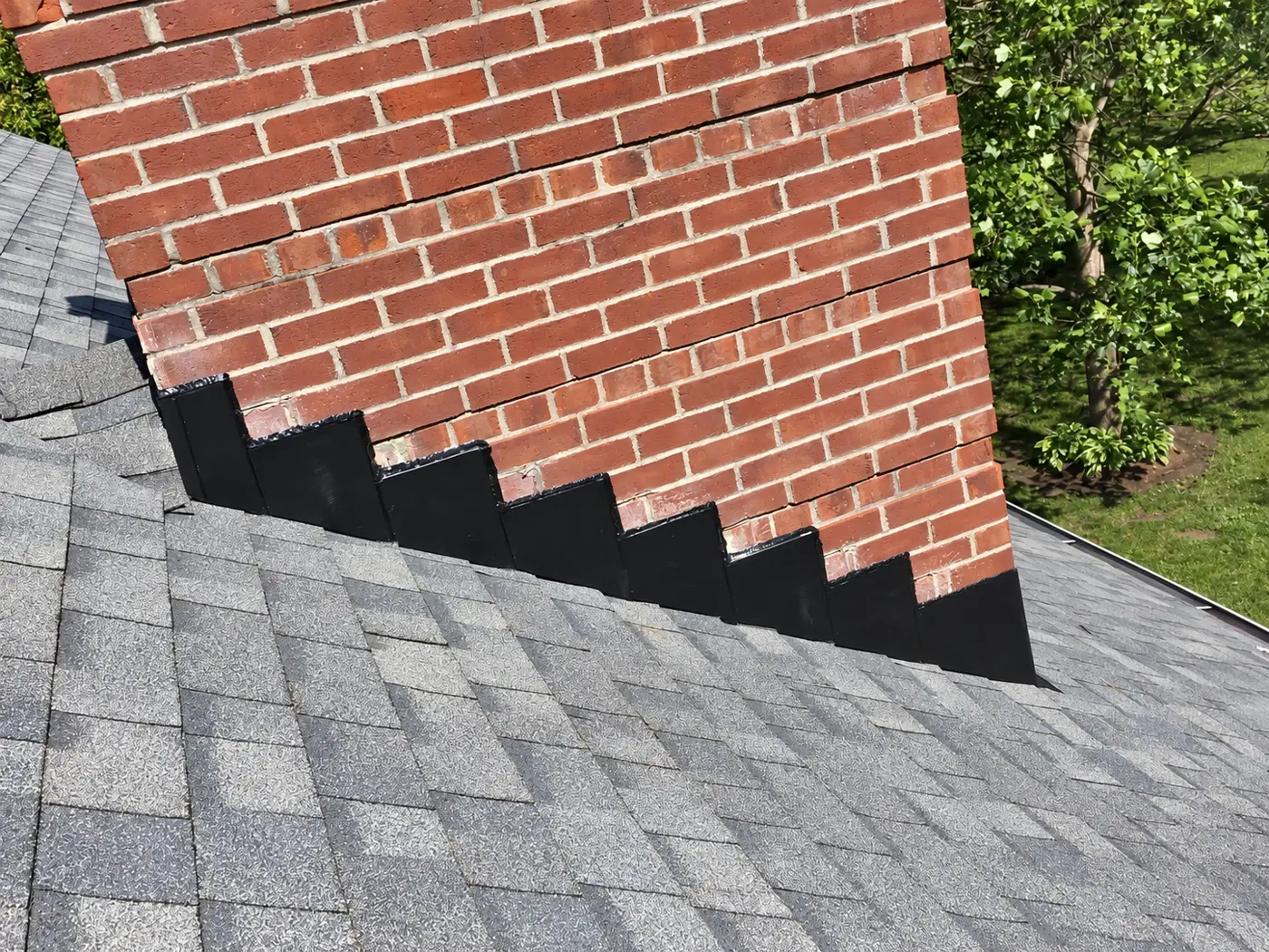 New step flashing on a brick chimney