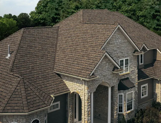 New dimensional shingles on a stone and siding home